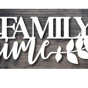 May include: White wooden sign with the text "FAMILY time" in a cursive font with a stylized leaf design.