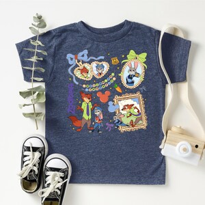 a blue t-shirt with a colorful graphic design, a pair of black and white sneakers, and a white camera.