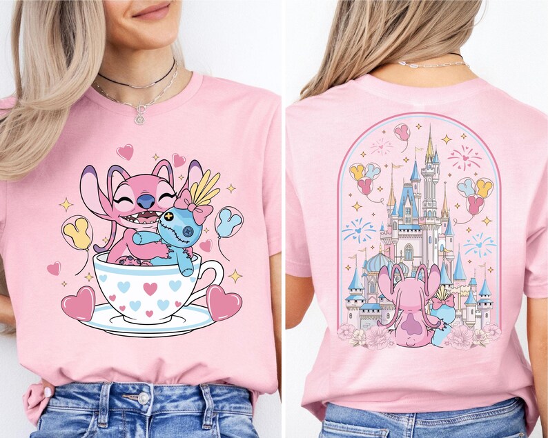 A woman wearing a pink t-shirt with a cartoon image of Stitch and a cup of tea, along with a castle and fireworks in the background.