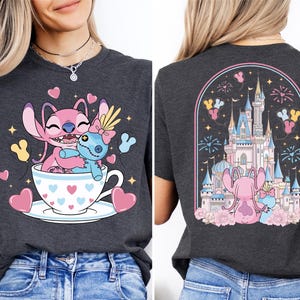 The image is a collage of two images. The left image shows a woman wearing a gray t-shirt with a cartoon design of two pink characters, one inside a teacup and the other sitting on a teacup, surrounded by hearts and fireworks. The right image shows the back of a woman's t-shirt with a graphic design of a castle and fireworks, with a pink character sitting on a castle and another pink character sitting on a castle.