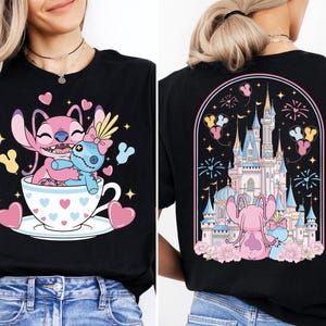 The image is a collage of two photos. The left photo shows a woman wearing a black t-shirt with a cartoon design of a pink character sitting in a teacup, surrounded by hearts and fireworks. The right photo shows the back of the same t-shirt, featuring a castle and fireworks in the background.