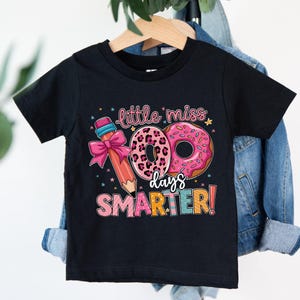 a black shirt that says little miss is smarter