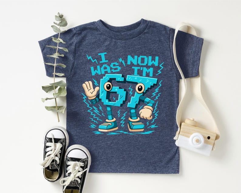A blue t-shirt with a cartoon character design, a pair of black and white sneakers, and a camera.