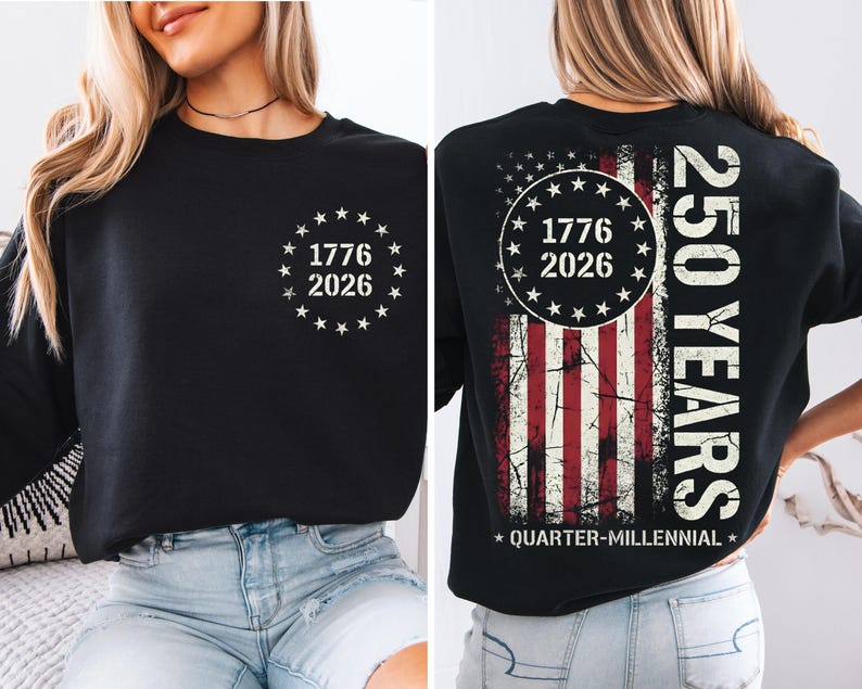 a woman wearing a black t-shirt with a graphic design on the back. The design includes a circle with the numbers 1776 and 2026, and an American flag pattern. The text on the t-shirt reads "250 YEARS" and "QUARTER-MILLENNIAL".