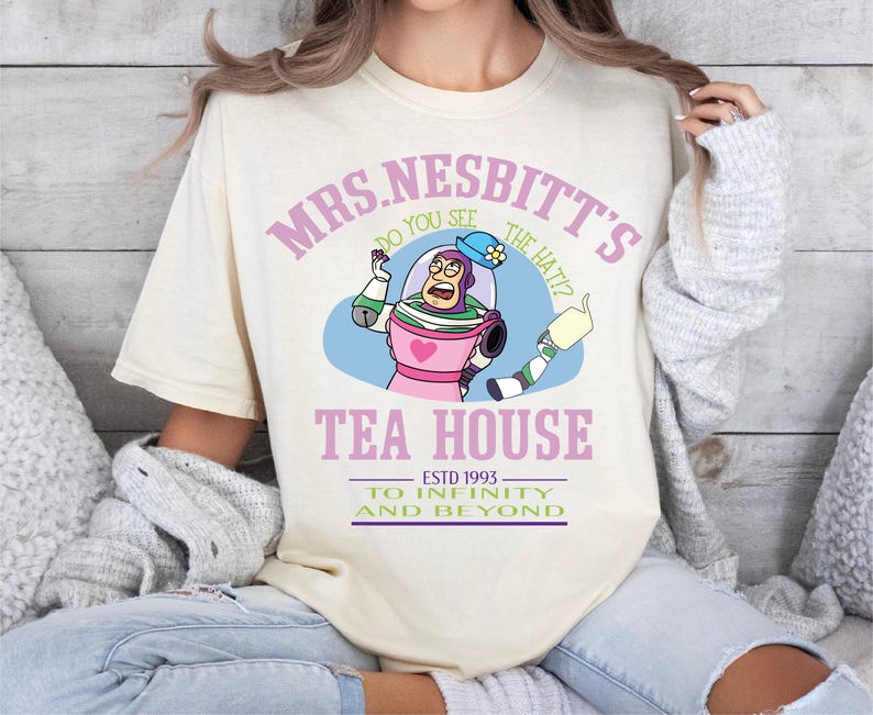 a woman wearing a t - shirt that says mrs nestt's tea house