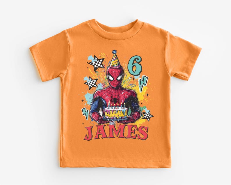 An orange t-shirt with a Spiderman graphic and the number 6, along with the text "JAMES" printed on it.