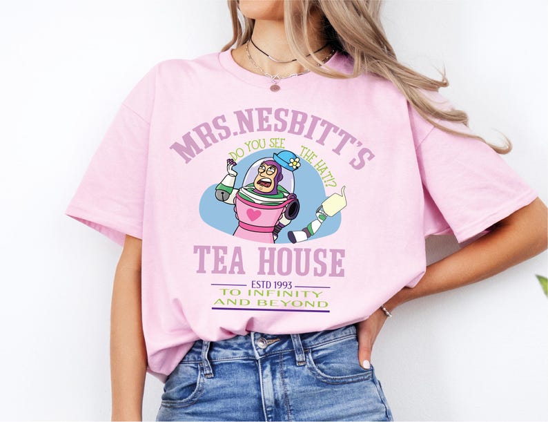 a woman wearing a pink shirt with a cartoon character on it