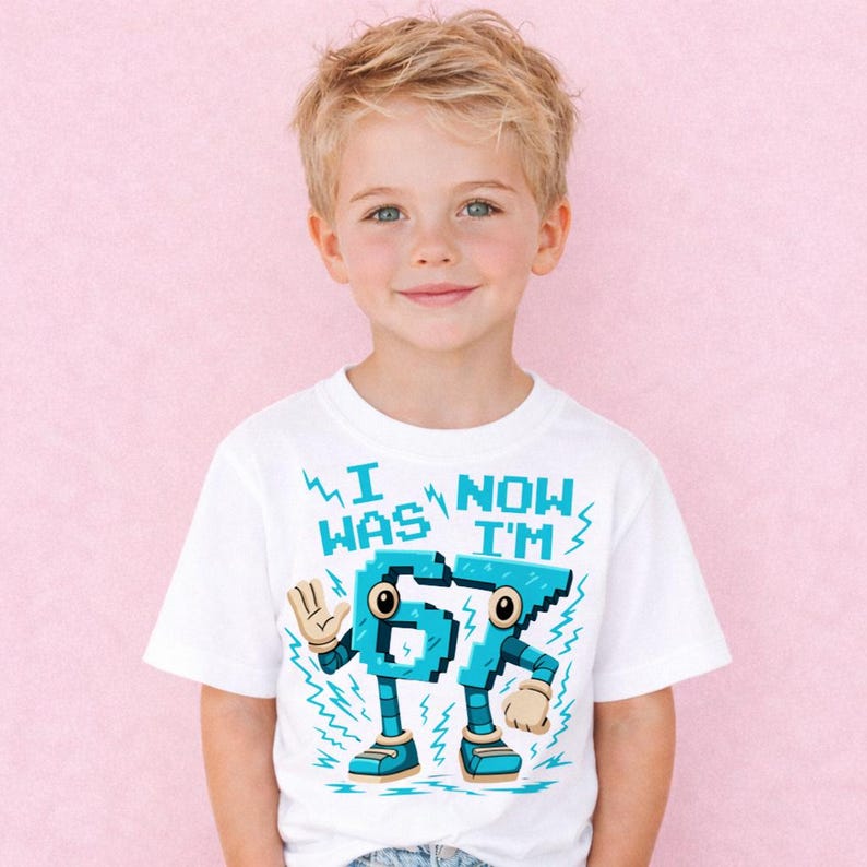 A young boy wearing a white t-shirt with a graphic design featuring a character in a blue and white color scheme.