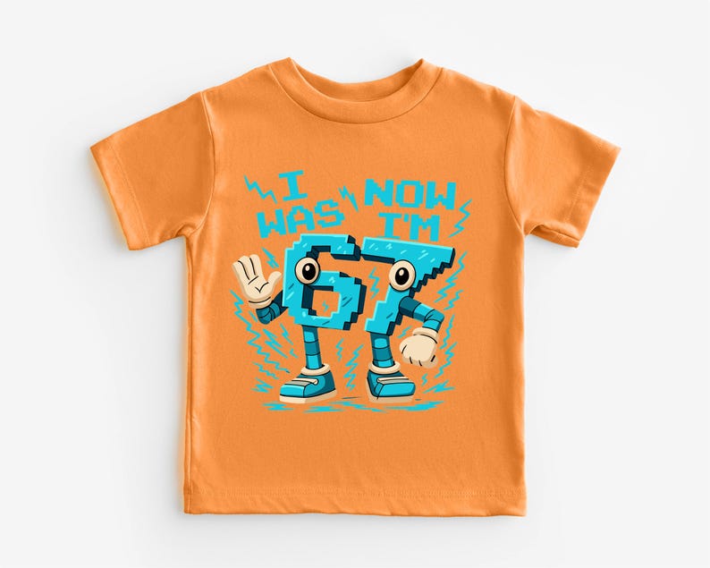 An orange t-shirt with a graphic design featuring a character made up of the number 6, with the text "I WAS NAMED 65" printed on it.