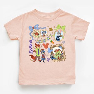 The image is a t-shirt featuring a collage of cartoon animal characters and various Disney-themed elements, such as a fox, a dog, and a cat.