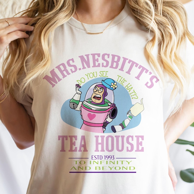 a woman wearing a t - shirt with a cartoon character on it