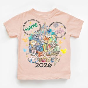 A pink t-shirt with a Disney-themed design featuring various Disney characters and the text "Disney 2020".