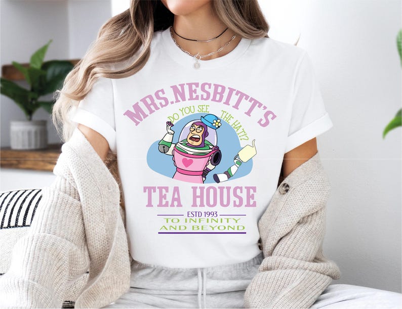 a woman sitting on a bed wearing a white shirt