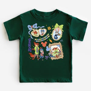 A green t-shirt with a collage of cartoon characters and illustrations, including a fox, a rabbit, and other animals.