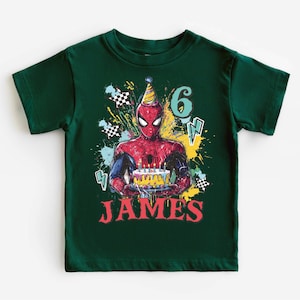 A green t-shirt with a Spider-Man graphic and the number 6, along with the text "JAMES" printed on it.