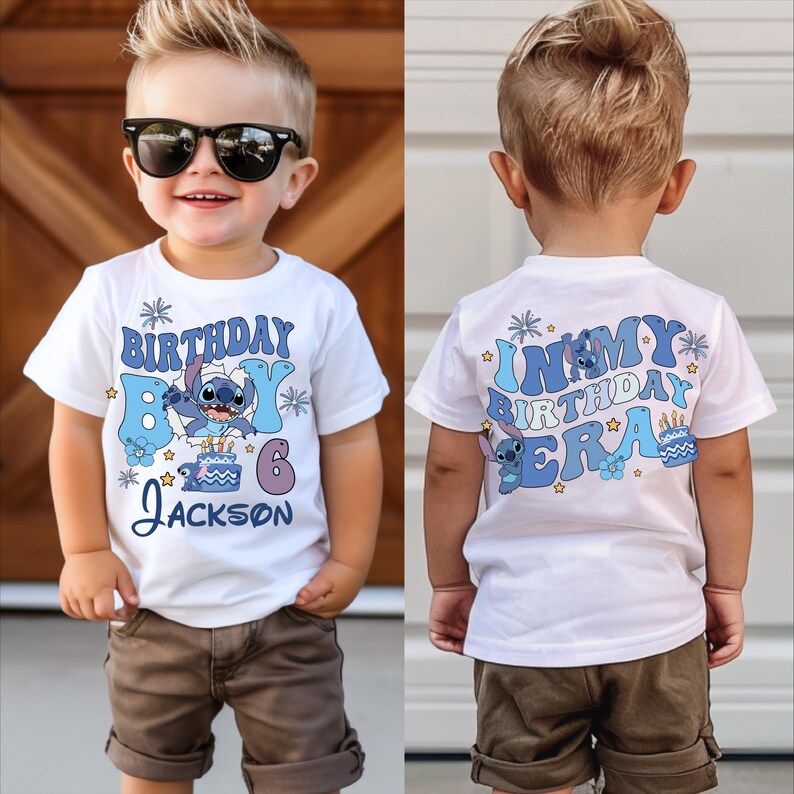 A young boy wearing a white t-shirt with a cartoon character and text, smiling and posing for a photo.