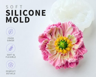 May include: A pink and yellow flower made with a soft silicone mold. The mold is white and in the shape of the flower. The text on the image says "SOFT SILICONE MOLD", "FOOD GRADE", "SOFT & FLEXIBLE", and "PERFECT DETAILS".