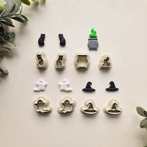 May include: A set of 10 Halloween-themed cookie cutters. The cutters are made of plastic and feature various designs, including cats, ghosts, witches' hats, and cauldrons.