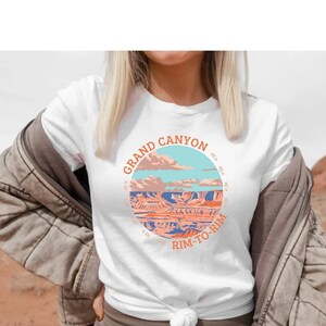 May include: White t-shirt with a graphic of the Grand Canyon and the text "Grand Canyon Rim-to-Rim".