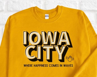 May include: Yellow sweatshirt with black text that reads "IOWA CITY" and "WHERE HAPPINESS COMES IN WAVES".