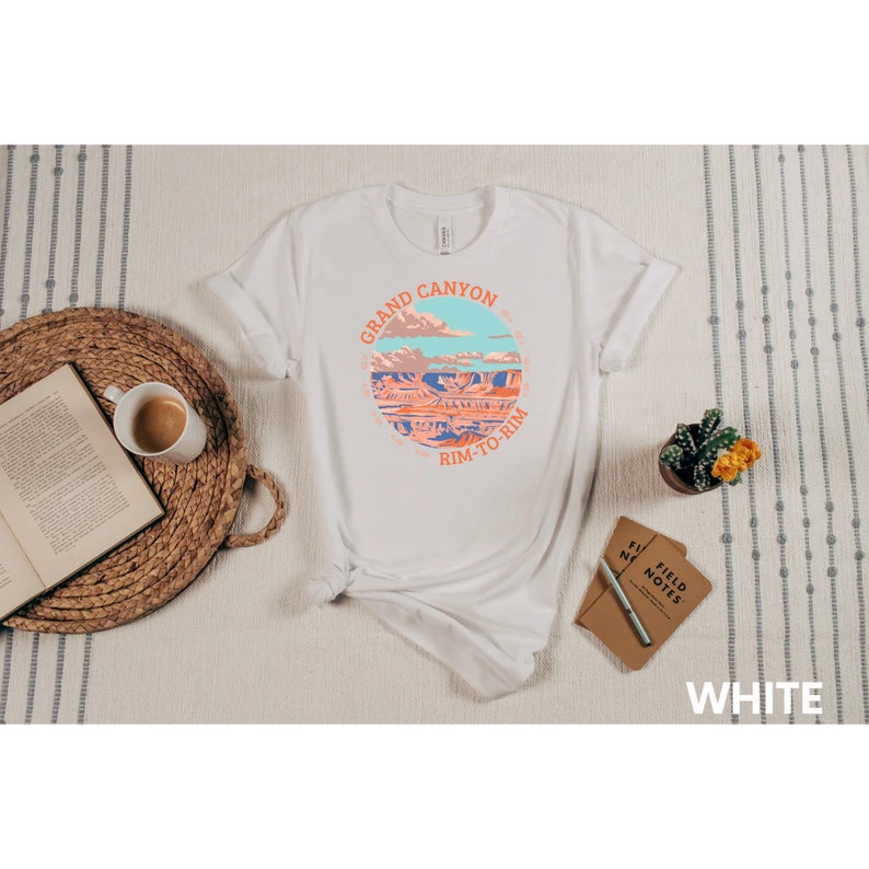 May include: White t-shirt with a graphic of the Grand Canyon and the text "Grand Canyon Rim-to-Rim".