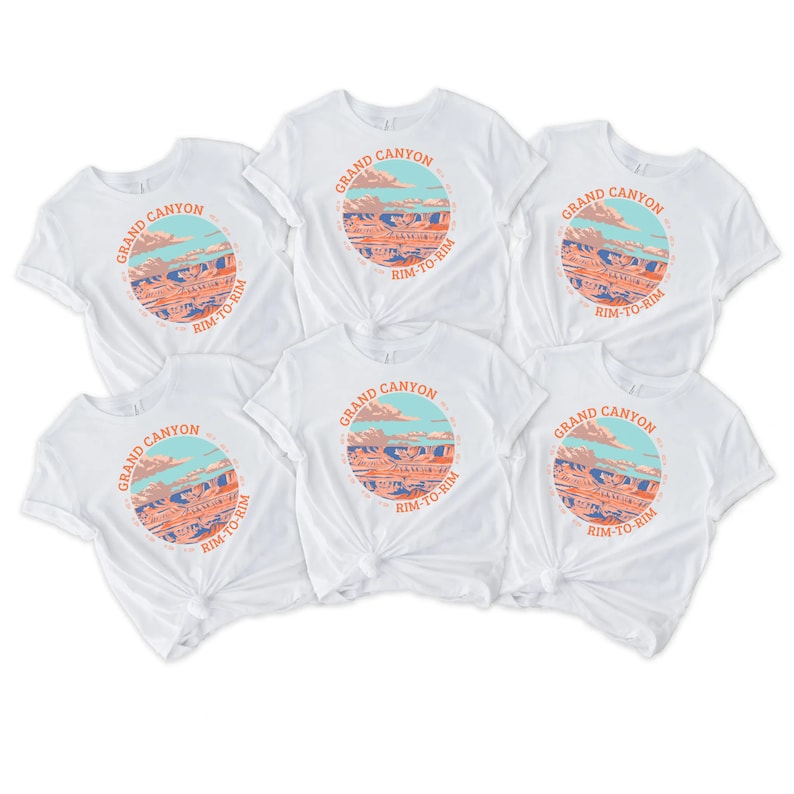 May include: Six white t-shirts with a graphic print of the Grand Canyon. The graphic features a colorful illustration of the canyon with the text "Grand Canyon" and "Rim-to-Rim" in a circle.