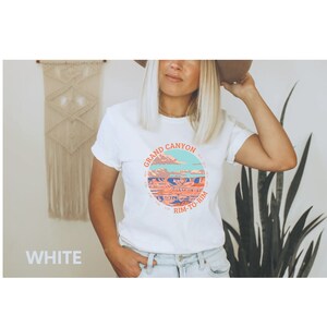 May include: White t-shirt with a graphic of the Grand Canyon and the text "Grand Canyon Rim-to-Rim".