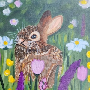 May include: An acrylic painting of a brown rabbit with textured fur sitting in a vibrant meadow. The scene is filled with colorful wildflowers, including white daisies, purple tulips, yellow buds, and tall lavender-colored stalks of flowers.