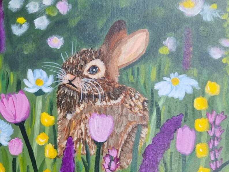 May include: An acrylic painting of a brown rabbit with textured fur sitting in a vibrant meadow. The scene is filled with colorful wildflowers, including white daisies, purple tulips, yellow buds, and tall lavender-colored stalks of flowers.