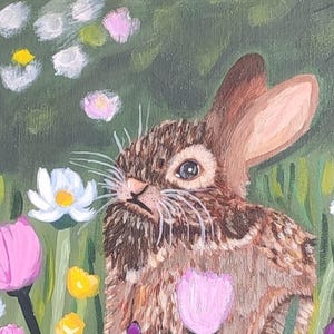 May include: An acrylic painting of a brown rabbit with textured fur, long ears, and white whiskers, positioned in a vibrant meadow filled with white daisies, pink tulips, and purple wildflowers against a deep green background.
