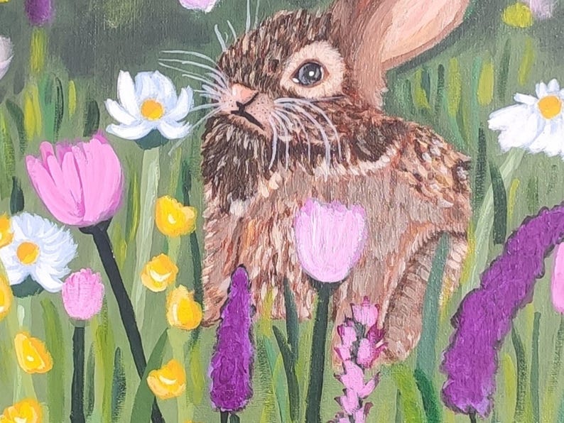 May include: An acrylic painting of a brown rabbit with textured fur sitting in a vibrant meadow. The scene features white daisies, pink tulips, small yellow wildflowers, and tall purple stalks set against a lush green background.