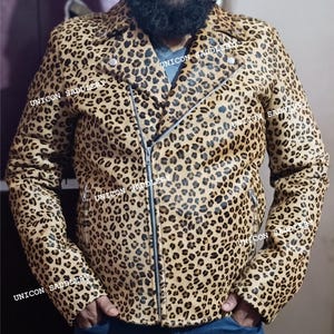 May include: A brown leather jacket with a leopard print pattern. The jacket has a zipper closure and a collar. The jacket is made of genuine leather and has a soft, comfortable feel.