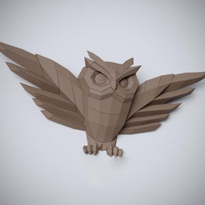 May include: A brown paper owl with its wings spread out. The owl is made of folded paper and has a geometric design.