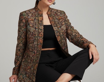 May include: A long-sleeved blazer featuring a dark, intricate paisley pattern in shades of orange, green, and gold. The blazer has a structured collarless neckline and a straight-cut silhouette, worn over a black crop top and black trousers.