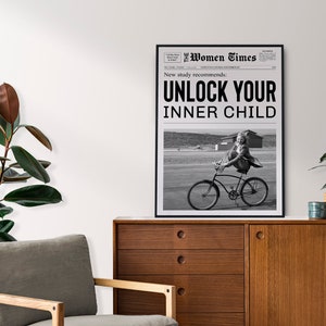 May include: Black and white newspaper print with the headline "Unlock Your Inner Child" and a photo of a girl riding a bicycle.