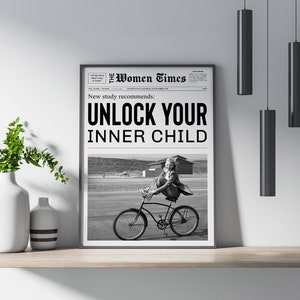May include: A black and white newspaper clipping with the headline "New study recommends: UNLOCK YOUR INNER CHILD". The image shows a young girl riding a bicycle.