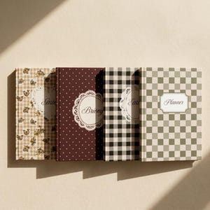 May include: Four hardcover planners arranged side-by-side. The first features a beige gingham and floral pattern, the second is dark maroon with white polka dots, the third has a black and white buffalo check, and the fourth is a sage green checkerboard.