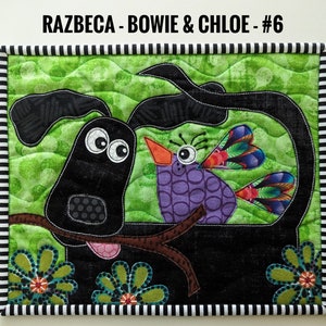 May include: A black dog with big eyes and a purple bird with a green, red, and black patterned wing. The dog and bird are on a green background with brown branches. The image has a black and white striped border and the text "RAZBECA - BOWIE & CHLOE - #6".