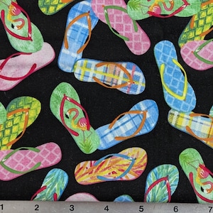 May include: Black fabric with a repeating pattern of colorful flip-flops. The flip-flops are in shades of pink, blue, green, and yellow, with various patterns including plaid and diamond shapes. Some feature a flamingo design.