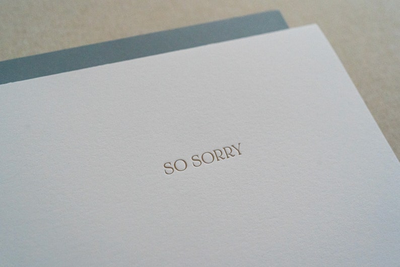 Detail of So Sorry text on sympathy card with blue envelope