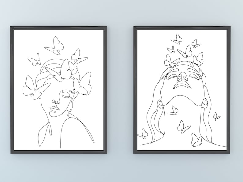 May include: Two black framed prints with white line drawings of a woman's face with butterflies around her. The woman in the left print has butterflies around her head and the woman in the right print has butterflies around her neck.