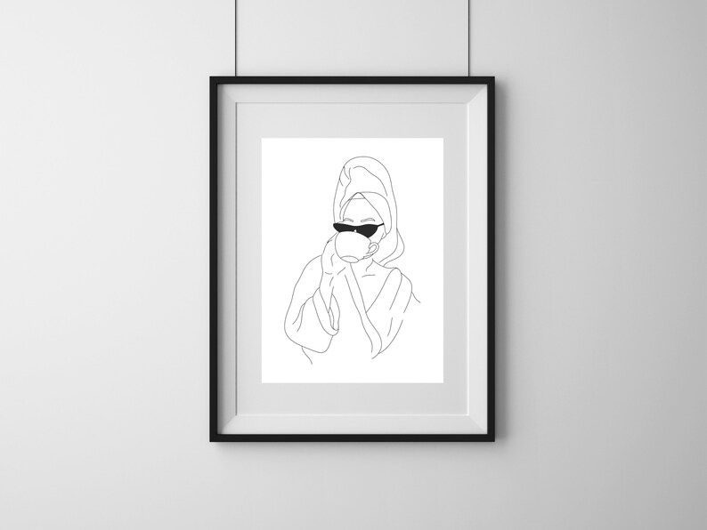 May include: Line art print of a person wearing a towel on their head and sunglasses, holding a cup in one hand.