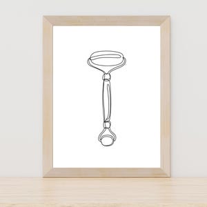 Op de afbeelding: Een zwart-witte lijntekening van een gezichtsroller, een schoonheidstool die wordt gebruikt voor gezichtsmassage.