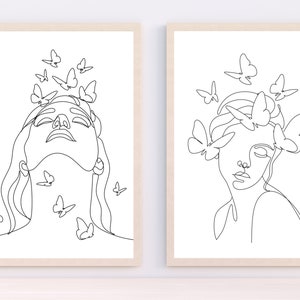May include: Two black and white line drawings of women's faces with butterflies around their heads. The woman on the left has her eyes closed and her head tilted back. The woman on the right has her eyes open and her head tilted to the side.