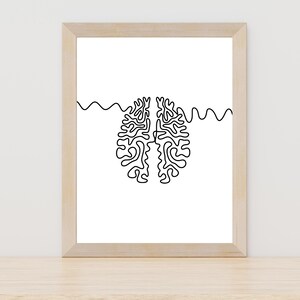 May include: A framed print of a black and white line drawing of a brain with wavy lines on either side.