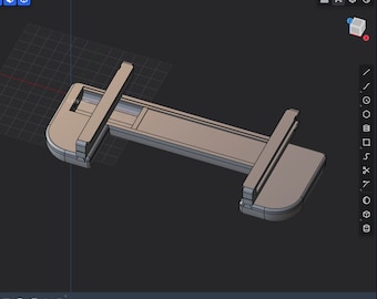 May include: A 3D model of a gray plastic clamp with a rectangular shape and rounded edges. The clamp is designed to hold two pieces of material together.