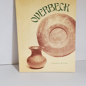 May include: A book titled "Overbeck" by Kathleen R. Postle, featuring a photograph of two brown pottery pieces on a yellow background.