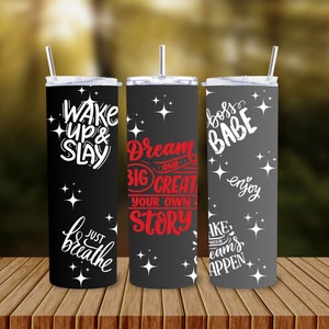 May include: Three stainless steel tumblers with straws. One is black with the text "Wake Up & Slay" and "Just Breathe", another is black with "Dream Big and Create Your Own Story", and the last is grey with "Boss Babe" and "Enjoy". Each has star designs.