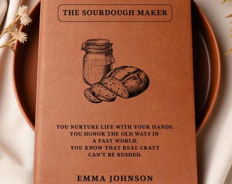 May include: A brown leather-bound journal titled "THE SOURDOUGH MAKER" with an illustration of a jar and bread. The journal includes text: "YOU NURTURE LIFE WITH YOUR HANDS...EMMA JOHNSON."