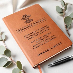 Brown leather mechanic journal, a personalized car guy gift with embossed emblem and MECHANIC JOURNAL title, custom text.